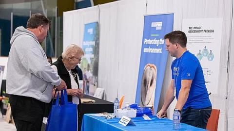 An NWMO employee explains the impact assessment process at an event